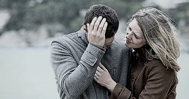 Woman comforting a sad man in winter