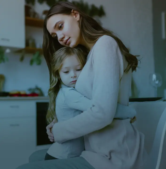 mother and daughter in a sad embrace